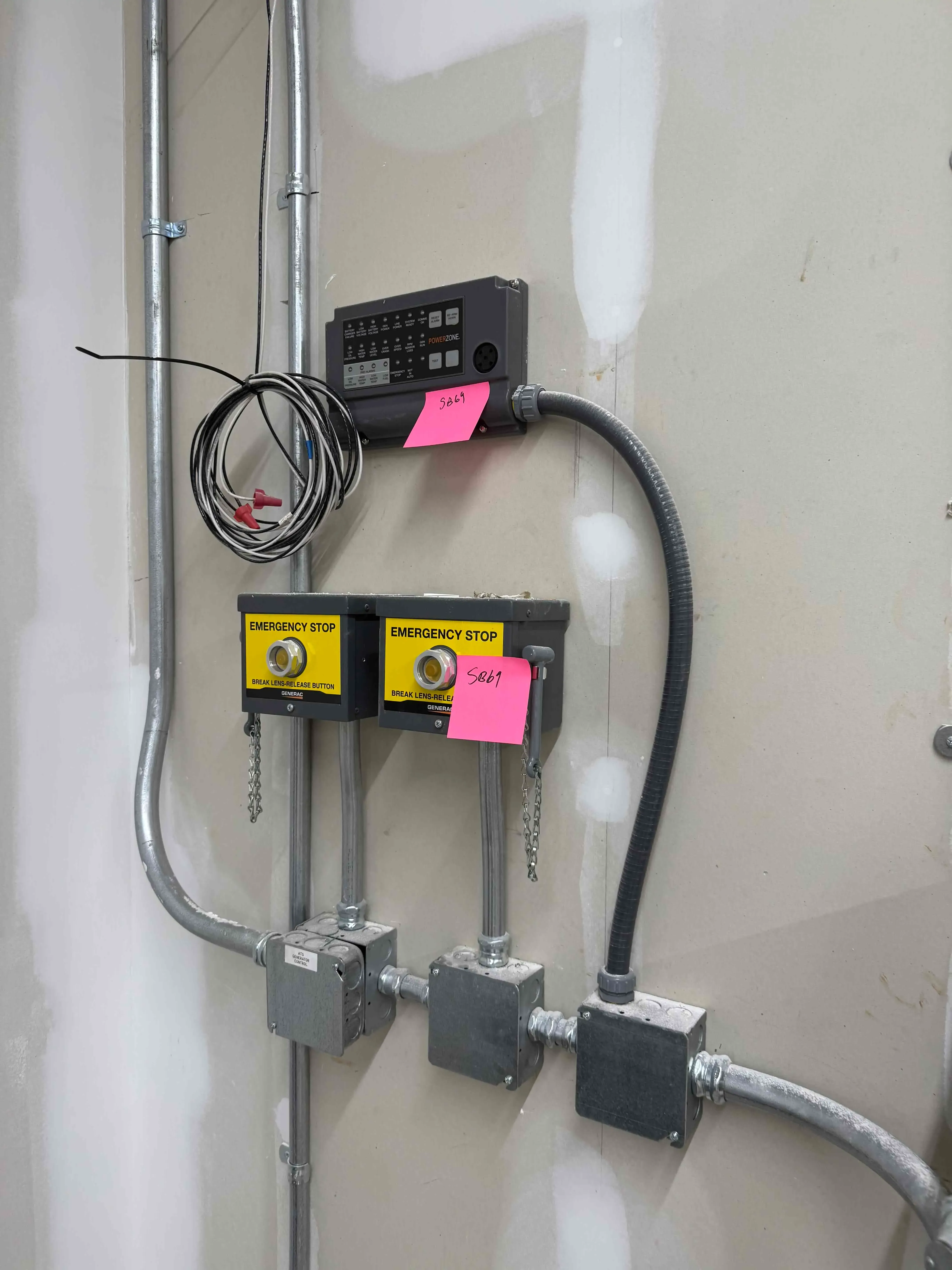 SB69: Generac / ASCO PowerZone Generator Control Panel with Dual Emergency Stop Stations – Wall-Mounted Safety and Monitoring System for Backup Power Integration