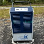 Two Model 701600 dehumidifiers, featuring high capacity for moisture removal, suitable for large spaces, displayed in good condition.