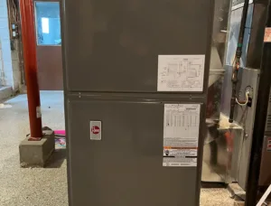 Image of a used Rheem 5 Ton Heat Pump RHPL-HM6024JC, showcasing its large size and robust construction.