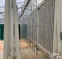 Used white, one-sided ZipGrow Towers located near Boonsboro, MD, stacked tightly, maximizing space and light efficiency for enhanced plant growth.