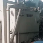 2005 Dresser Rand steam turbine generator set in a greenhouse farming environment, demonstrating its application in sustainable agriculture.