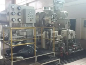 2005 Dresser Rand steam turbine generator set in a greenhouse farming environment, demonstrating its application in sustainable agriculture.
