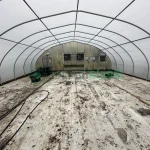 Interior view of the vent end of the X.S. Smith Quonset Cold Frame greenhouse labeled CF03 at White's Greenhouse Auction on SecondBloom Auctions platform, featuring essential vent equipment.