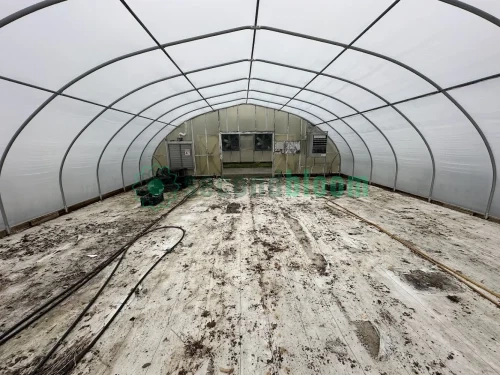 Interior view of the vent end of the X.S. Smith Quonset Cold Frame greenhouse labeled CF03 at White's Greenhouse Auction on SecondBloom Auctions platform, featuring essential vent equipment.