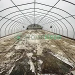 Interior view of the vent end of the X.S. Smith Quonset Cold Frame greenhouse labeled CF03 at White's Greenhouse Auction on SecondBloom Auctions platform, featuring essential vent equipment.