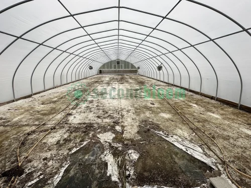 Interior view of the vent end of the X.S. Smith Quonset Cold Frame greenhouse labeled CF03 at White's Greenhouse Auction on SecondBloom Auctions platform, featuring essential vent equipment.