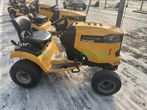 Side view of the yellow Cub Cadet XT1 LT42 lawn tractor, model 13AOA1CS056, showcasing its nursery cart attachment hitch.