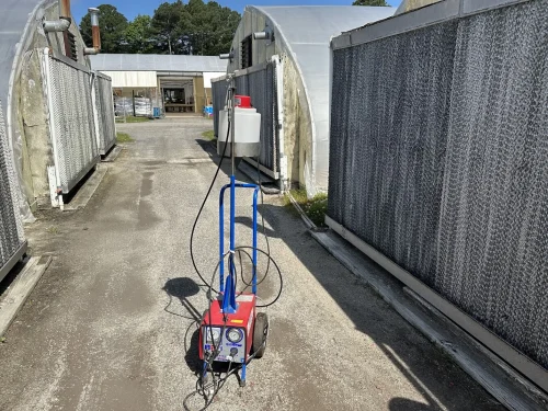 Close-up of the Dramm Mini AutoFog head for efficient chemical application in greenhouses.