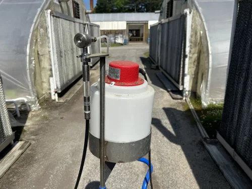 Close-up of the Dramm Mini AutoFog head for efficient chemical application in greenhouses.