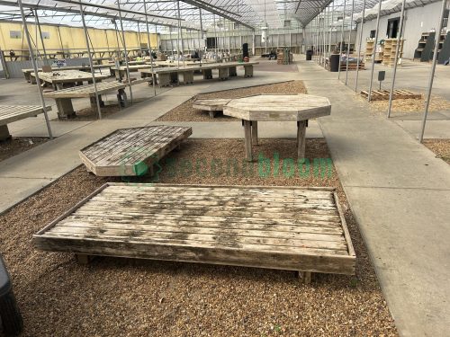 Side view of garden center greenhouse benches from White's Nursery, highlighting their durable construction and practical design for plant display.