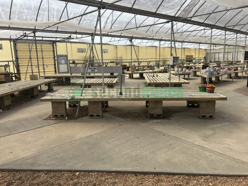 Side view of garden center greenhouse benches from White's Nursery, highlighting their durable construction and practical design for plant display.