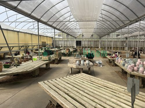 Full view of garden center greenhouse benches from White's Nursery, showcasing their sturdy construction and optimal layout for plant display.