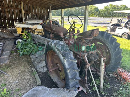 Side view of a Farmall 230 tractor showcasing its classic design and robust construction.