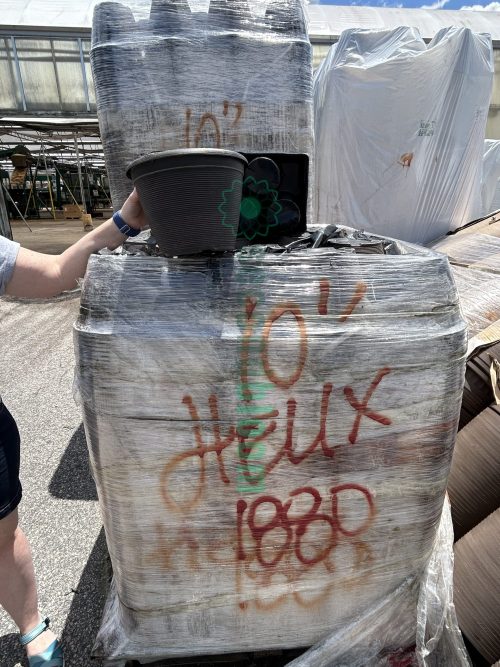 Three pallets of 10-inch Helix Pots, suitable for indoor and outdoor plant cultivation.