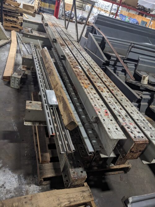 Various structural components, including beams and panels, stored as spare parts for the vertical farm system at Your Local Greens in Burlington, NC, originally from the FarmedHere system in Bedford Park, IL.