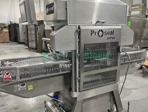 Rear view of the Proseal GTO tray sealer showing conveyor and components