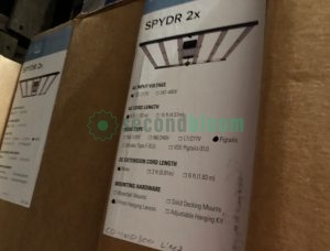 Seventeen professional Fluence SPYDR 2p LED grow light fixtures arranged for auction sale, showing ultra-slim 1.3-inch profile design with 47-inch length anodized aluminum chassis, detachable power supplies, and integrated passive cooling heatsinks, each unit featuring PhysioSpec Indoor full-spectrum LED arrays for commercial horticultural applications with 4x4 foot coverage area