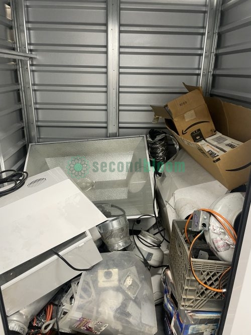 Assorted grow equipment in storage unit, including light hoods, ballasts, and wiring