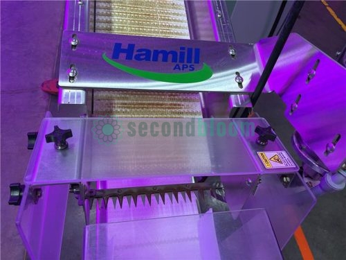 Cutting blade area of the Hamill APS microgreen harvester with protective clear shields and a Hamill brand plate