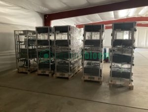 Multiple stainless steel rack units for the Aetrium 2.448 Smart Farm system on pallets in a warehouse