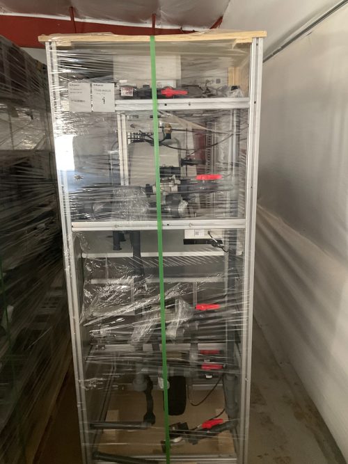 Plastic-wrapped Aetrium hydroponic growing module on pallet showing horizontal tray configuration