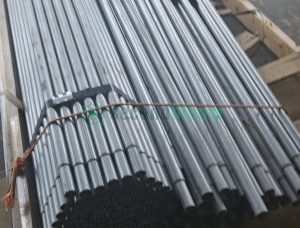 Close-up of galvanized steel bench components showing white PVC connector pieces integrated with metal frame parts