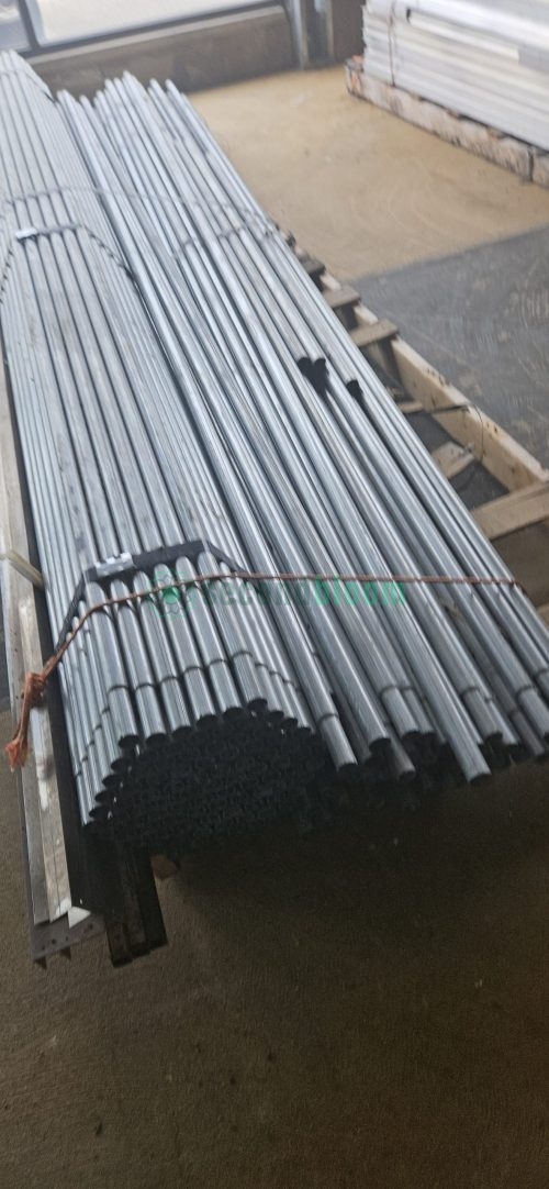 Close-up of galvanized steel bench components showing white PVC connector pieces integrated with metal frame parts