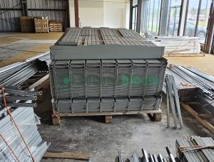 Bundle of galvanized steel pipes for commercial greenhouse rolling bench construction stacked on wooden pallet