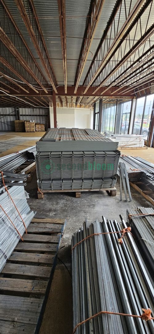 Bundle of galvanized steel pipes for commercial greenhouse rolling bench construction stacked on wooden pallet