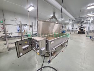 Industrial tray washer with open control panel showing electrical components