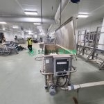 Large industrial tray washing system installed in commercial food processing facility
