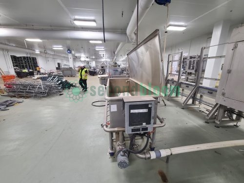 Large industrial tray washing system installed in commercial food processing facility