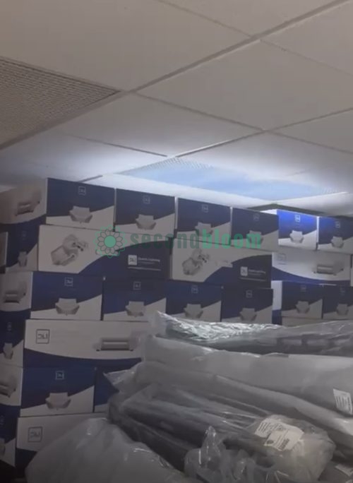 Large warehouse inventory of boxed grow lights stacked on pallets, showing scale of commercial lighting liquidation
