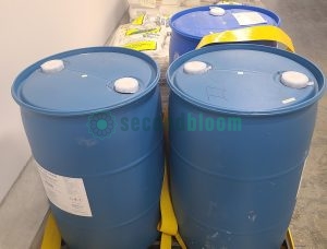 Three 55-gallon drums of EnviroTech Irrigation Line Cleaner on spill containment pallet for controlled environment agriculture maintenance