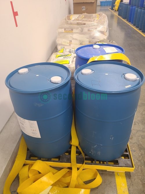 Three 55-gallon drums of EnviroTech Irrigation Line Cleaner on spill containment pallet for controlled environment agriculture maintenance