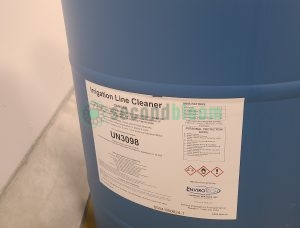 Close-up of EnviroTech Irrigation Line Cleaner drum label showing UN3098 classification and HMIS ratings for CEA system maintenance