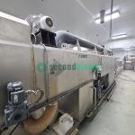 LIMEX industrial tunnel washer installed in food processing facility showing drive motors and utility connections