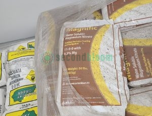 Magnific 11-0-0 Water Soluble Magnesium Nitrate fertilizer next to Kentucky Green bags showing comparative packaging in climate-controlled storage