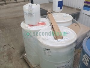 Mixed lot of Ecolab Quorum Clear V sanitizer containers including drums and smaller jugs for varied controlled environment agriculture applications