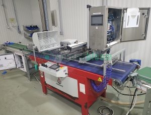 Automated seeding system with touchscreen control panel, perforated drum assembly and conveyor system in clean room environment