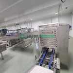Roopack filling equipment with control panel, conveyor belt system, and access door in vertical farming facility