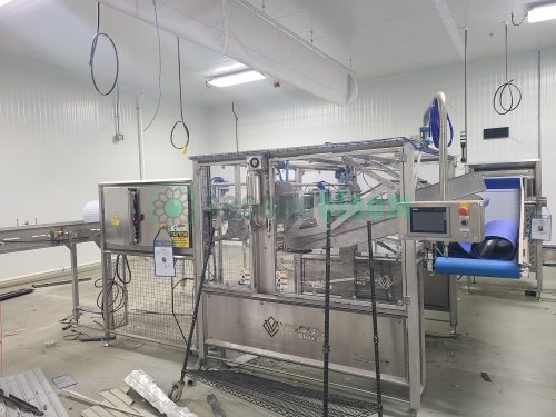 Viscon harvesting system with touchscreen control panel, safety enclosures, and conveyor integration in food processing facility