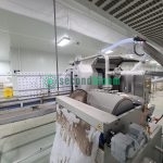 Viscon washing system showing drum assembly, ventilation connections, and drive motor in food processing facility