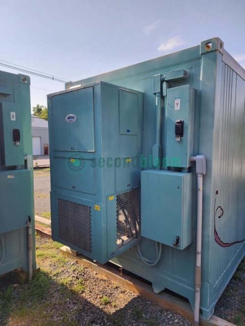 Corner view of turquoise container farm showing ventilation equipment, electrical conduits, and partial side mural with plant designs
