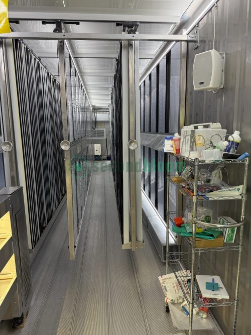 Metal framework and vertical growing towers inside hydroponic container farm