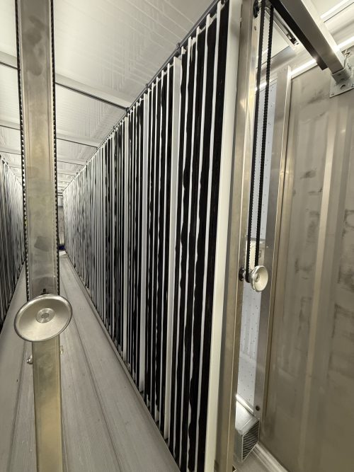 Clean vertical growing channels with LED panels ready for new crop cycle in container farm