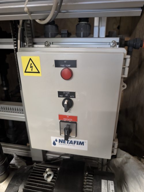 Netafim fertigation control panel with emergency stop button and system controls for greenhouse irrigation management