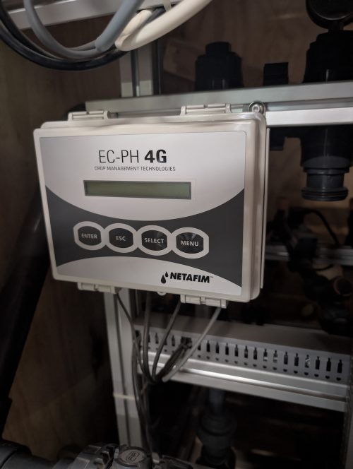 Digital EC pH meter display showing 4.6 reading for greenhouse nutrient solution monitoring