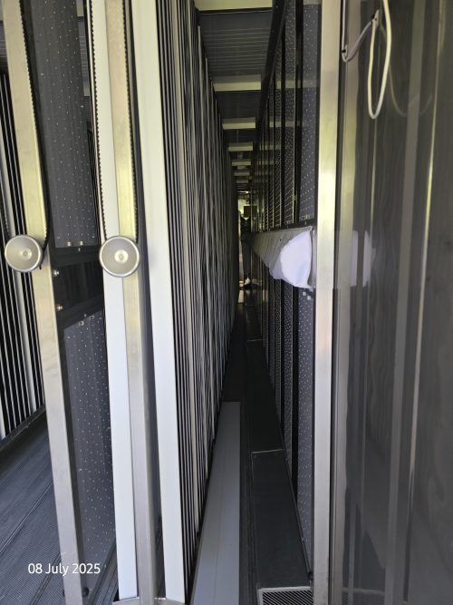 Freight Farms controlled environment agriculture container interior walkway with vertical farming racks and LED lighting systems