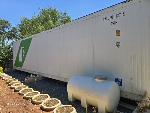Freight Farms branded controlled environment agriculture container with external support equipment for vertical farming operations